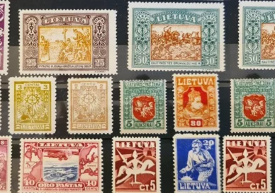 A collection of early Lithuanian postage stamps from 1918 to 1940, showcasing the Vytis and other national symbols.