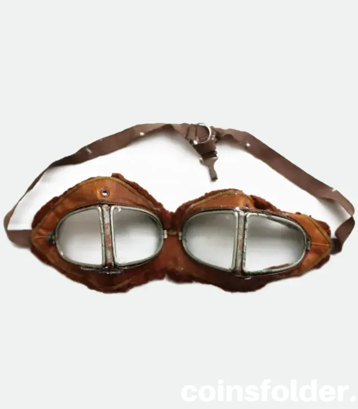 Vintage 1900s motoring and early WWI flying goggles with nickel-plated steel frames, leather face mask, and green silk backing.