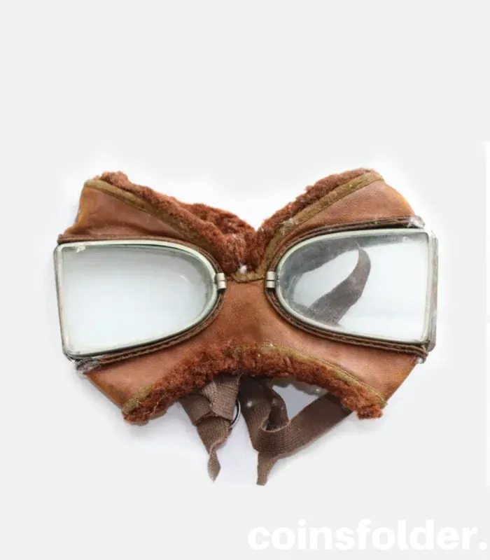 Vintage 1900s motoring and early WWI flying goggles with nickel-plated steel frames, leather face mask, and green silk backing.