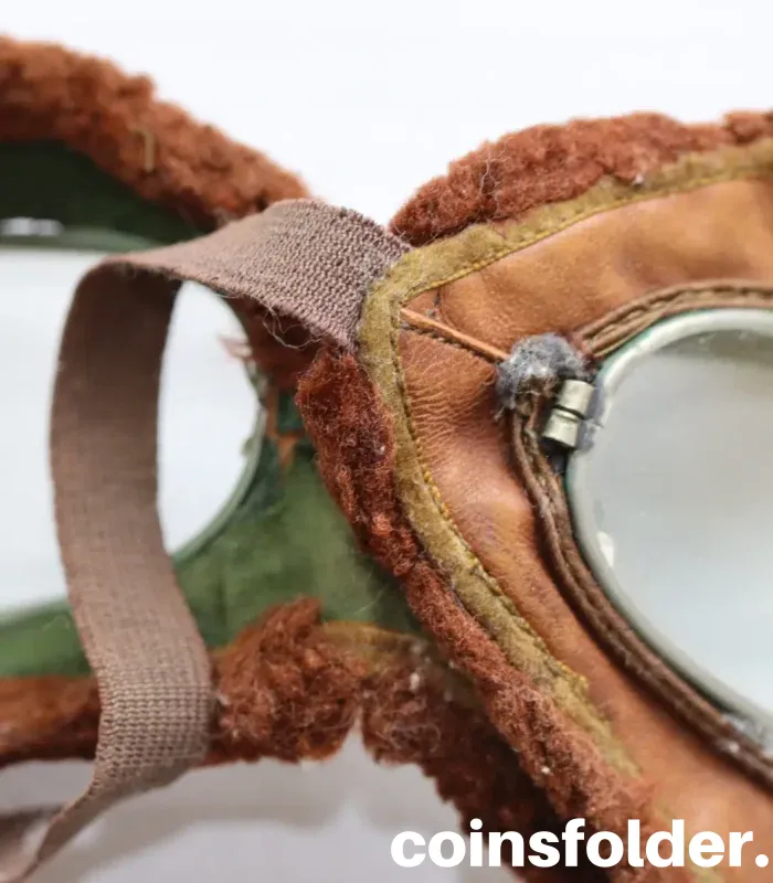 Vintage 1900s motoring and early WWI flying goggles with nickel-plated steel frames, leather face mask, and green silk backing.