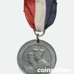 1937 Coronation Medal of King George VI & Queen Elizabeth with blue, white, and red ribbon.