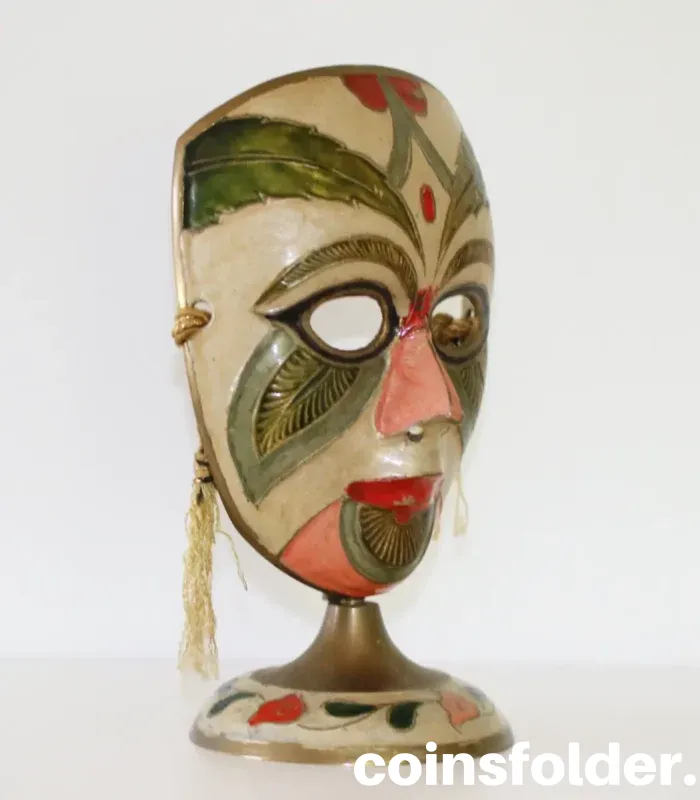 Vintage painted brass carnival mask statuette with colorful design