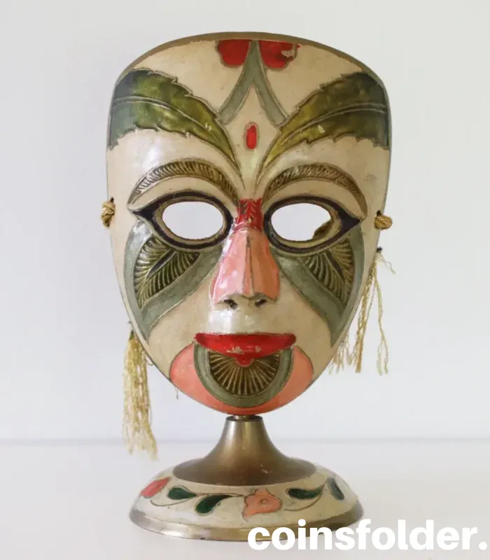 Vintage painted brass carnival mask statuette with colorful design