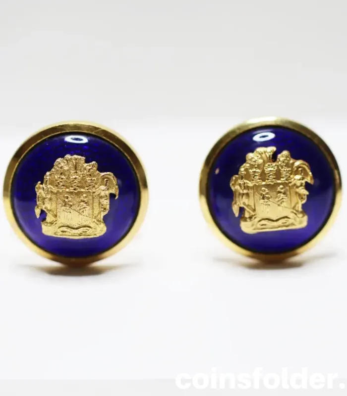 A pair of vintage livery cufflinks adorned with the Family Crest of Von Platen, set against a vibrant blue enamel background.