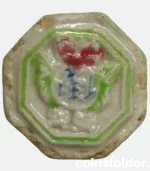 Siam porcelain gambling token with green, red, and blue glaze